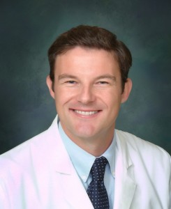 A man in white lab coat and tie.