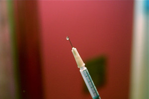 A needle with an arrow sticking out of it.